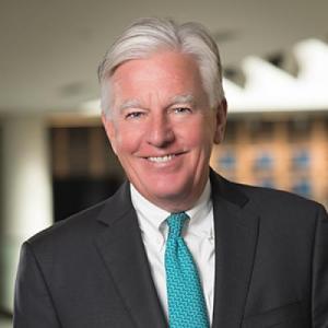 marty meehan, a light-skinned, older gentleman with white hair in a dark suit, white shirt and turquoise neck tie